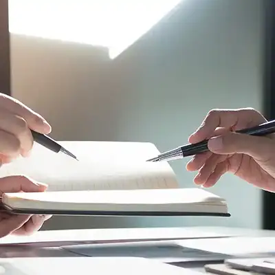 image of hands reviewing a financial ledger