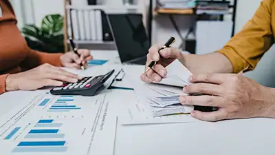 couple working on an internal audit review financials